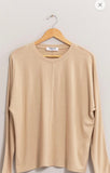 Beige top with front seam dolman sleeves for a casual look
