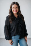 black blouse with ruffles and statement sleeves