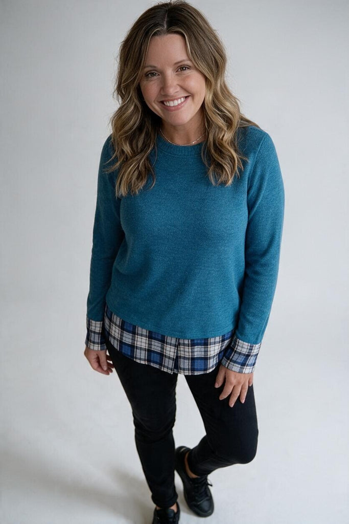 teal top with plaid trim at the sleeves and hem