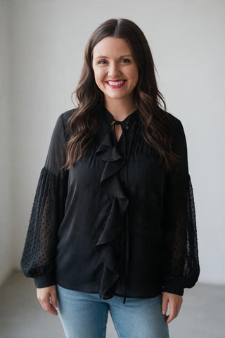 black blouse with ruffles and statement sleeves
