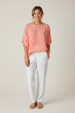 coral and white print top