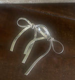 silver bow earrings in our boutique