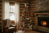 A decorated Christmas tree stands in a rustic log cabin living room next to a leather armchair and a stone fireplace with a burning fire.