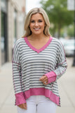 grey and white striped top with pink trim