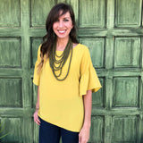 Mustard yellow top with ruffle bell sleeves in our boutique aunt lillie bells