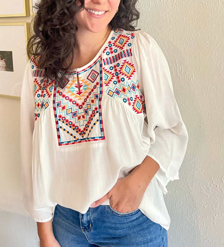 white ivory embroidered blouse, perfect for vacation in our boutique