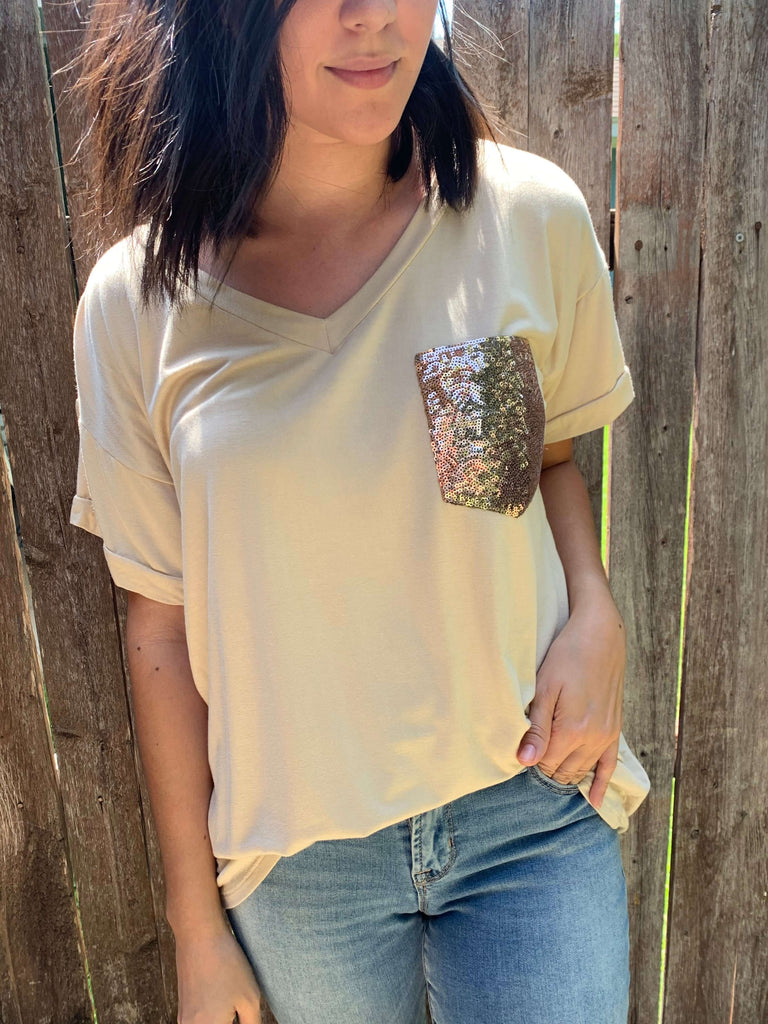 beige t-shirt with a gold sequin pocket in our boutique aunt lillie bells